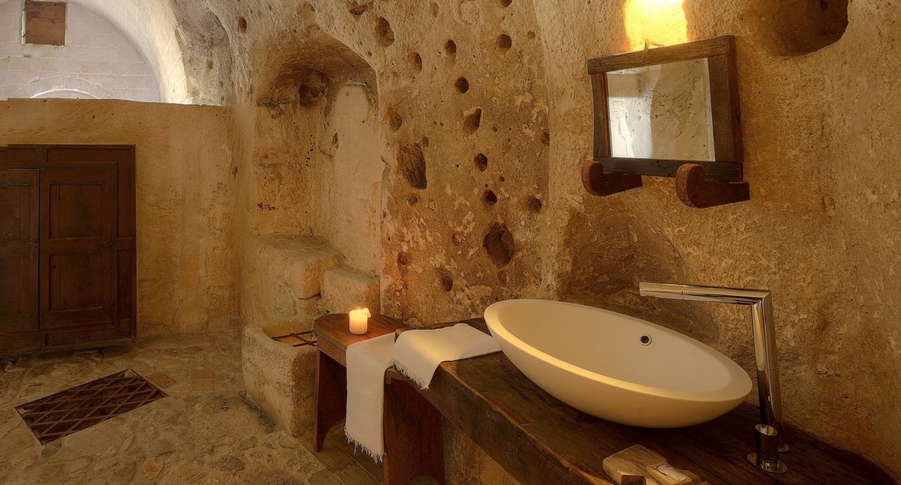 The Bathroom of the Cave number 6 at the Sextantio Le Grotte della Civita Hotel is located in a beguiling and strongly genuine environment
